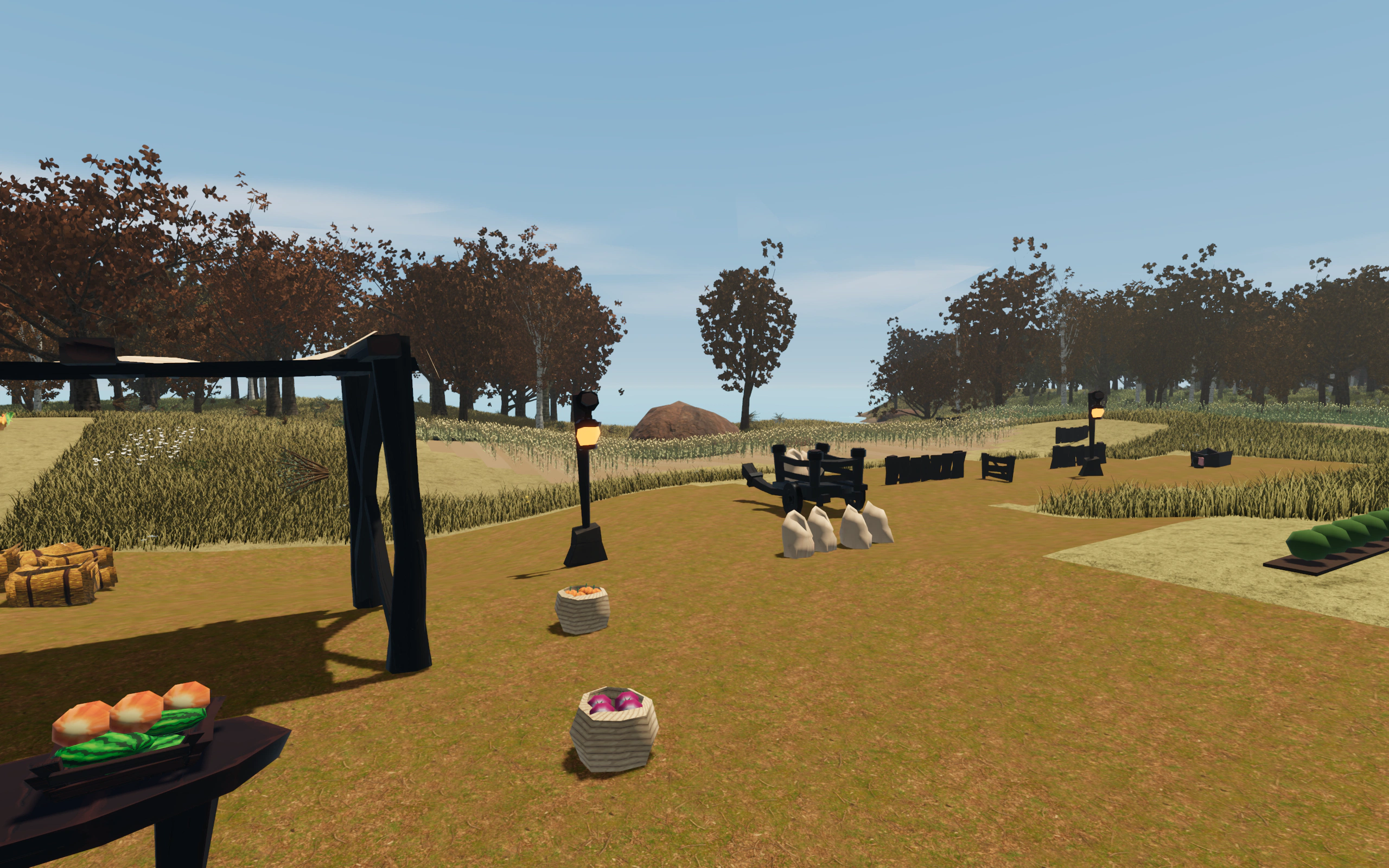 Produce baskets, sacks and a wooden cart beside Rivafonte’s crop fields and copper-leaved trees